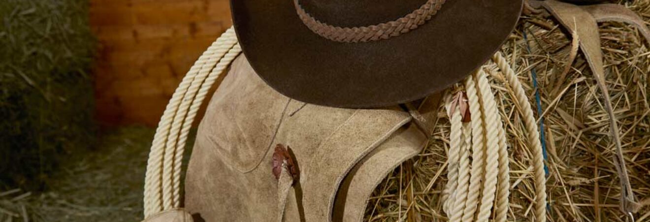 Hat and rope on hay bale