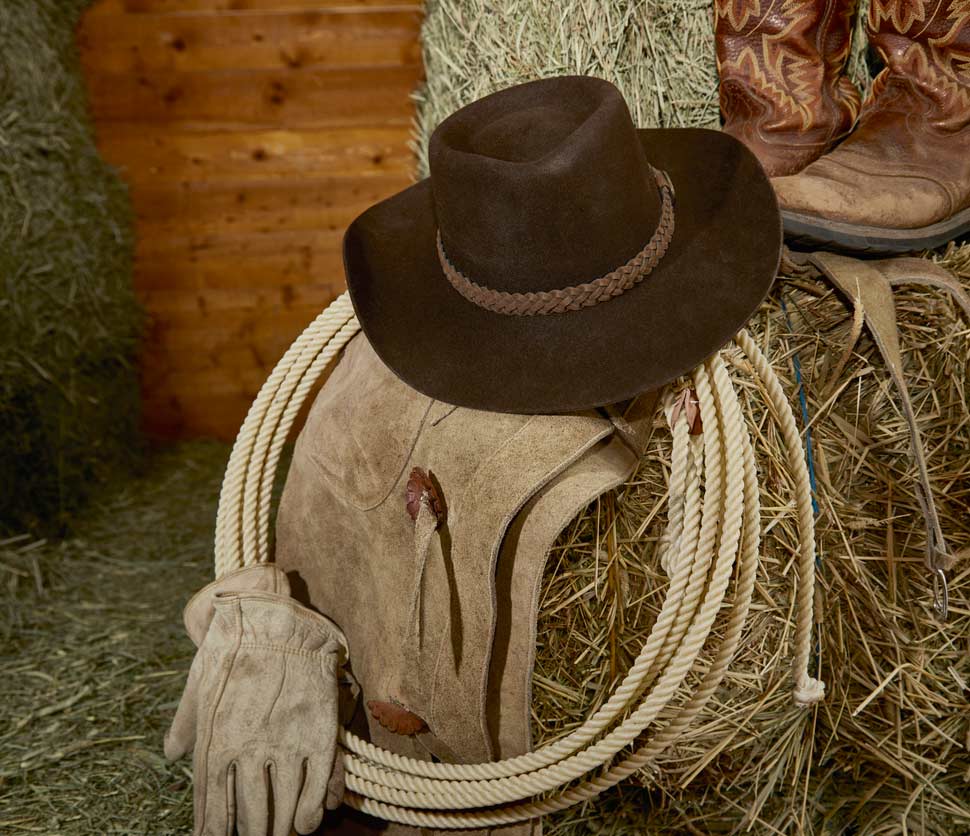 Hat and rope on hay bale